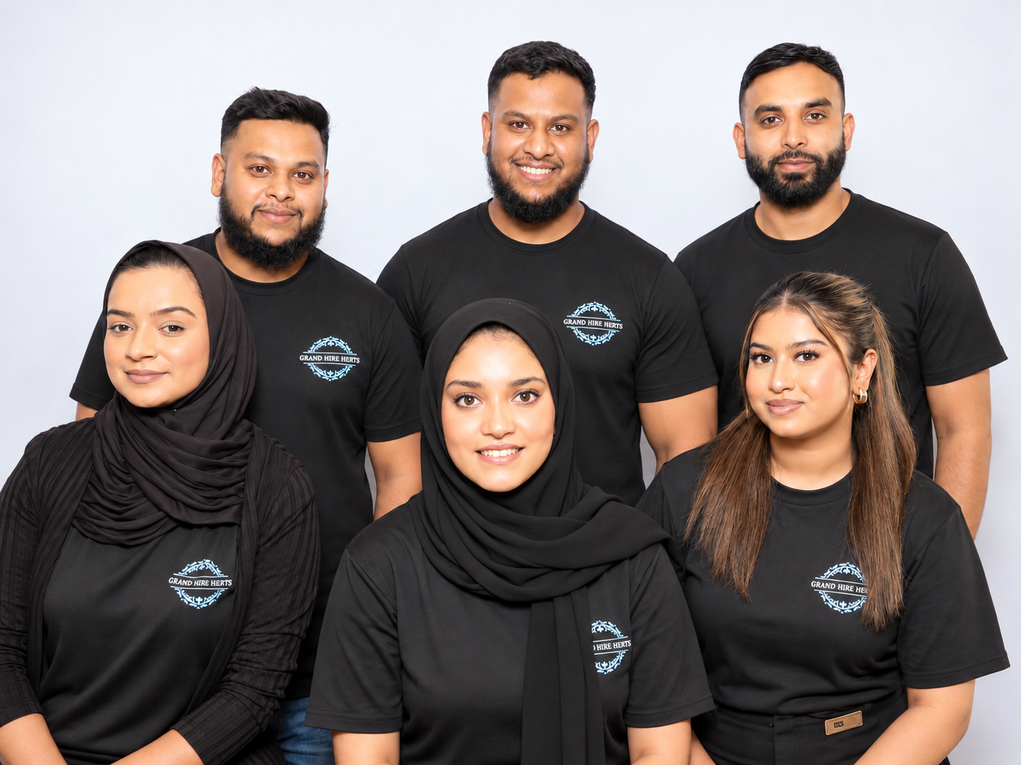 Grand Hire Herts team wearing matching black branded shirts.