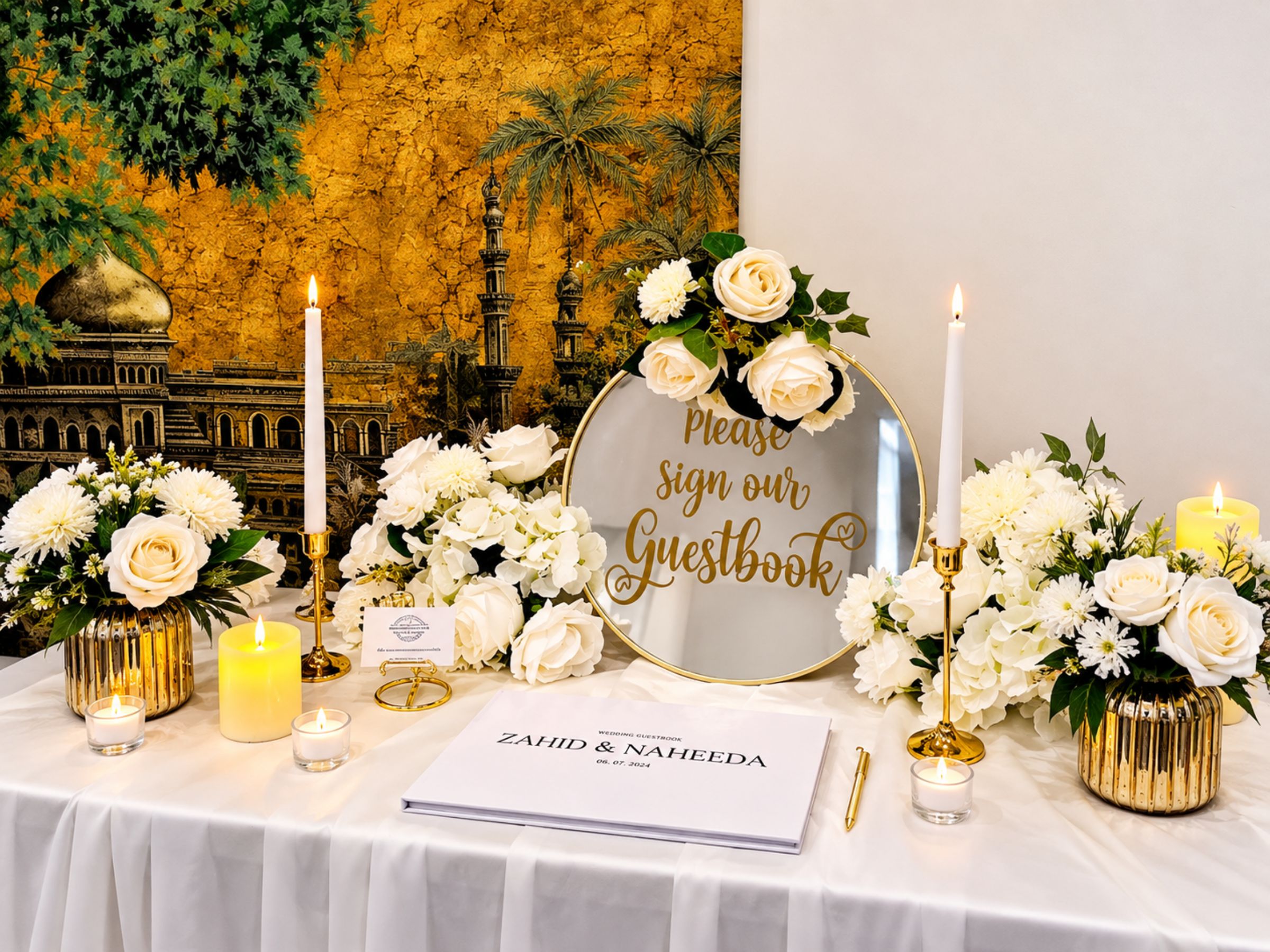 Guest-book table styled with white flowers, candles and gold details.