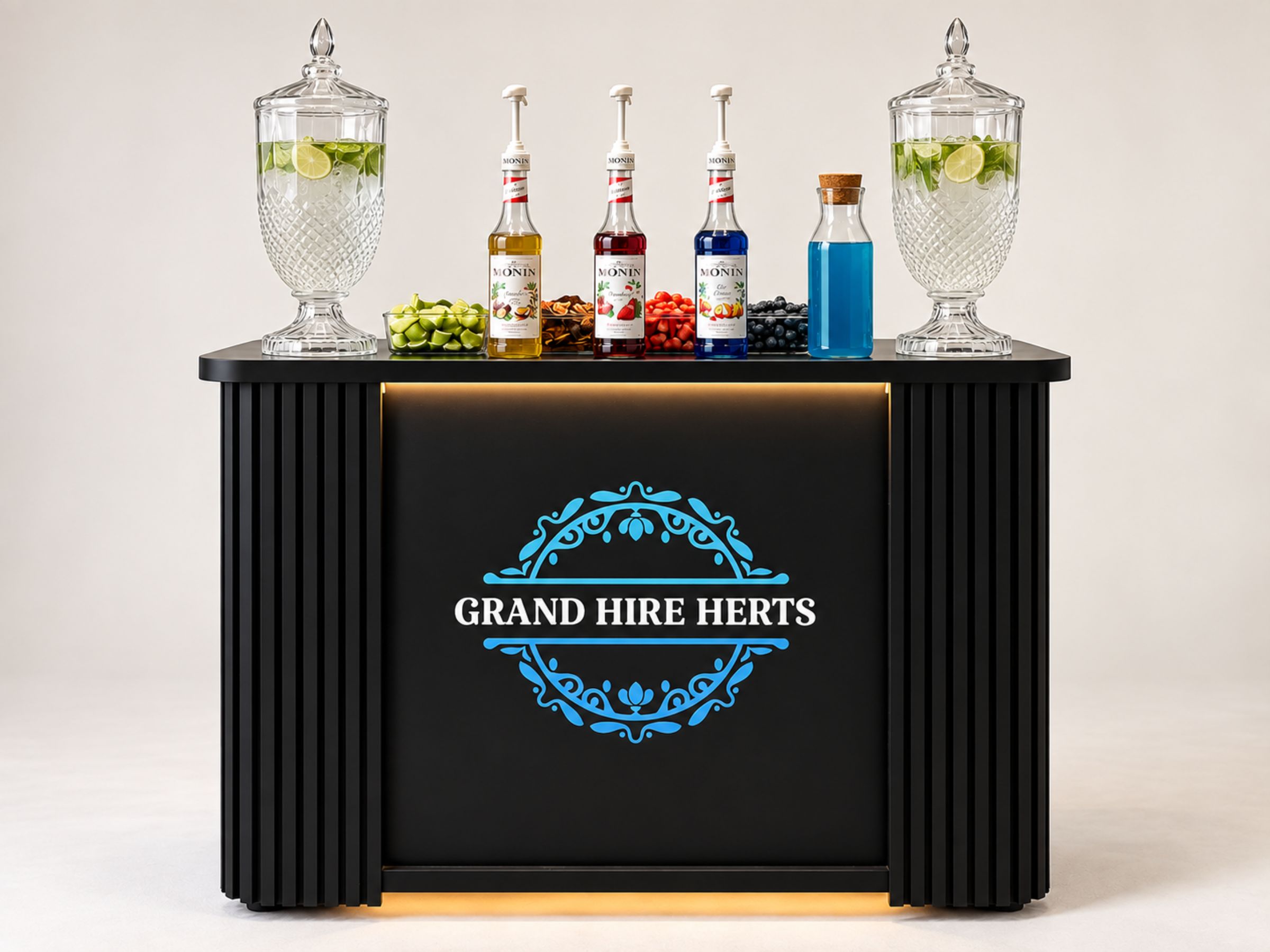 Black Grand Hire Herts mocktail cart arranged with dispensers, syrups and cups.